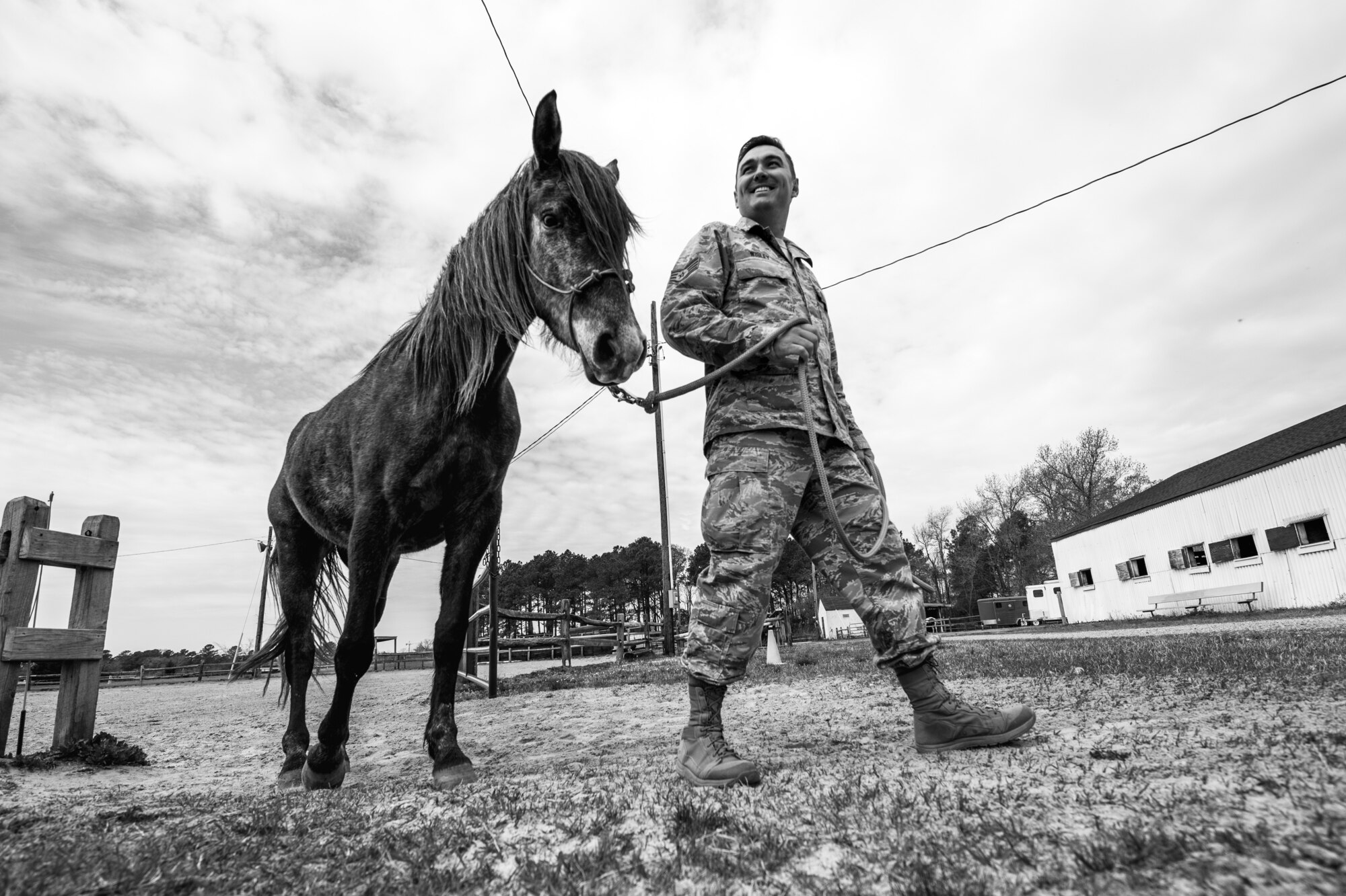 U.S. Air Force Staff Sgt. Cody Wisley, 83rd Network Operations Squadron boundary protection supervisor, guides his horse, Steel, at Joint Base Langley-Eustis, Virginia, April 12, 2018