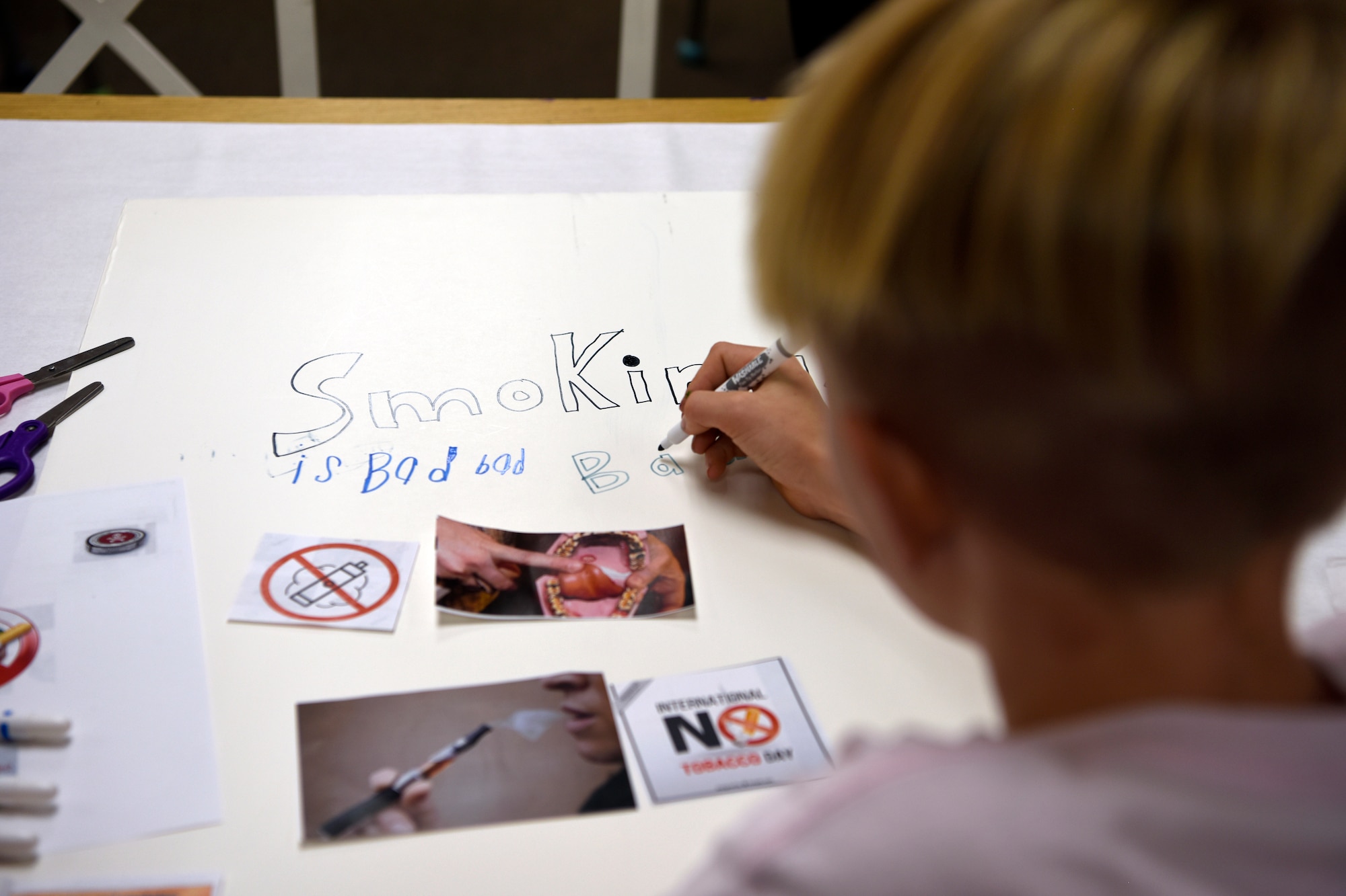 A child decorates an anti-smoking poster at the Youth Center Nov. 7, 2018, at Luke Air Force Base, Ariz.