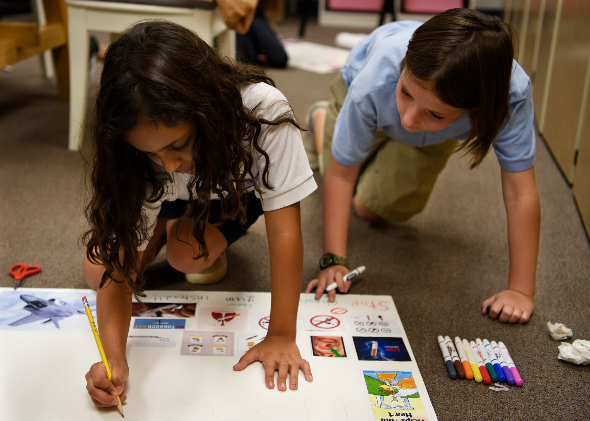 Children decorate a poster for the Great American Smokeout at the Youth Center Nov. 7, 2018, at Luke Air Force Base, Ariz.