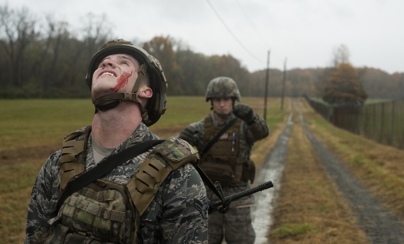 Airman 1st Class Jarrod Mohr, 87th Civil Engineer Squadron firefighter, and U.S. Air Force Staff Sgt. Morgan D. McDaniel, 514th Security Forces Squadron Phoenix Raven, carry a weighted stretcher during the teamed relay race portion of the 2018 Service Member of the Year Competition on Joint Base McGuire-Dix-Lakehurst, New Jersey, Nov. 5, 2018. The competition draws out some of the most competent and capable service members on base. Each military member represents their respective branch, competing against each other in a challenge to showcase the capabilities of the U.S. military. (U.S. Air Force photo by Airman 1st Class Ariel Owings)