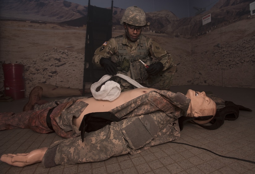 Sgt. 1st Class Andre Mangual, U.S. Army NCO Academy senior small group leader, performs tactical combat casualty care during the 2018 Service Member of the Year Competition on Joint Base McGuire-Dix-Lakehurst, New Jersey, Nov. 6, 2018. The competitors were evaluated at the Medical Simulation Training Center, where they had to apply life-saving first aid while under fire. (U.S. Air Force photo by Airman 1st Class Ariel Owings)