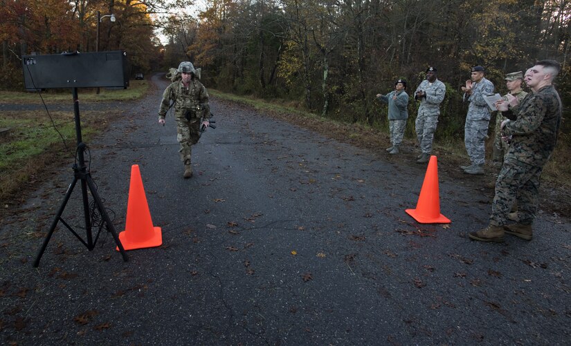 Sgt. 1st Class Mark Padifeld, 174th Infantry Brigade, 3rd Battalion, 314th Field Artillery Regiment fire support NCO observer and coach, crosses the finish line of the six-mile ruck march portion during the 2018 Service Member of the Year Competition on Joint Base McGuire-Dix-Lakehurst, New Jersey, Nov. 7, 2018. Competitors were required to finish the six miles under 90 minutes with a prescribed packing list weighing at least 35 pounds. (U.S. Air Force photo by Airman 1st Class Ariel Owings)