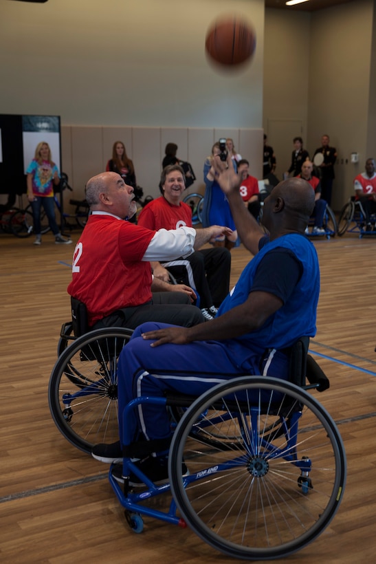 Teams Rolling Thunder(red) and Bayou Hurricanes(blue), face off in the tip-off of a wheelchair basketball game at the Southeast Veteran’s Hospital in New Orleans, Nov. 11, 2018.