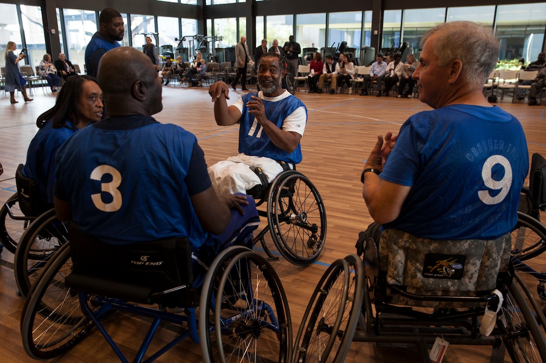 Teammates of the Bayou Hurricanes strategize during halftime of a wheelchair basketball game at the Southeast Veteran’s Hospital in New Orleans, Nov. 11, 2018.