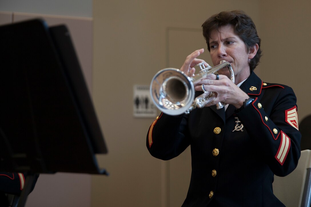 Staff Sgt. LeAnn Splitter, musician with the the Marine Forces Reserve Band, plays the trumpet before the start of a wheelchair basketball game at the Southeast Veteran’s Hospital in New Orleans, Nov. 11, 2018