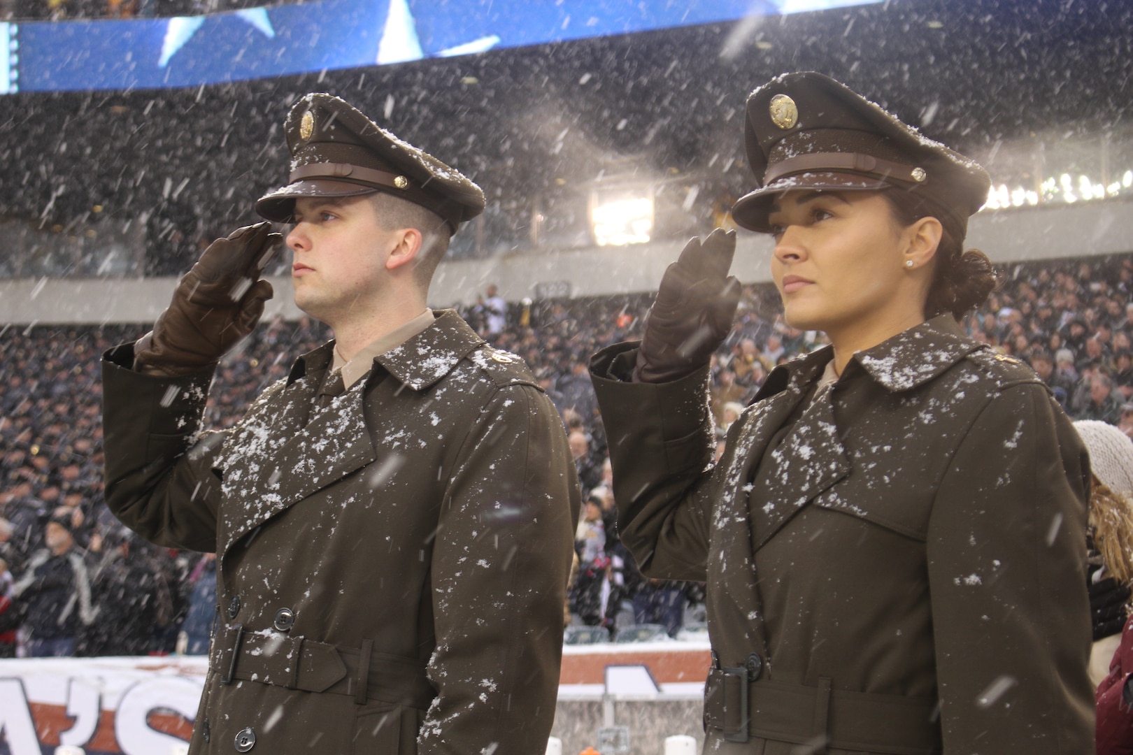Soldier Models of the proposed Pink and Green daily service uniform display the outfits overcoat, as they render the hand salute during the National Anthem at Lincoln Financial Field in Philadelphia, Pennsylvania, during the Army-Navy Game December 9, 2017.