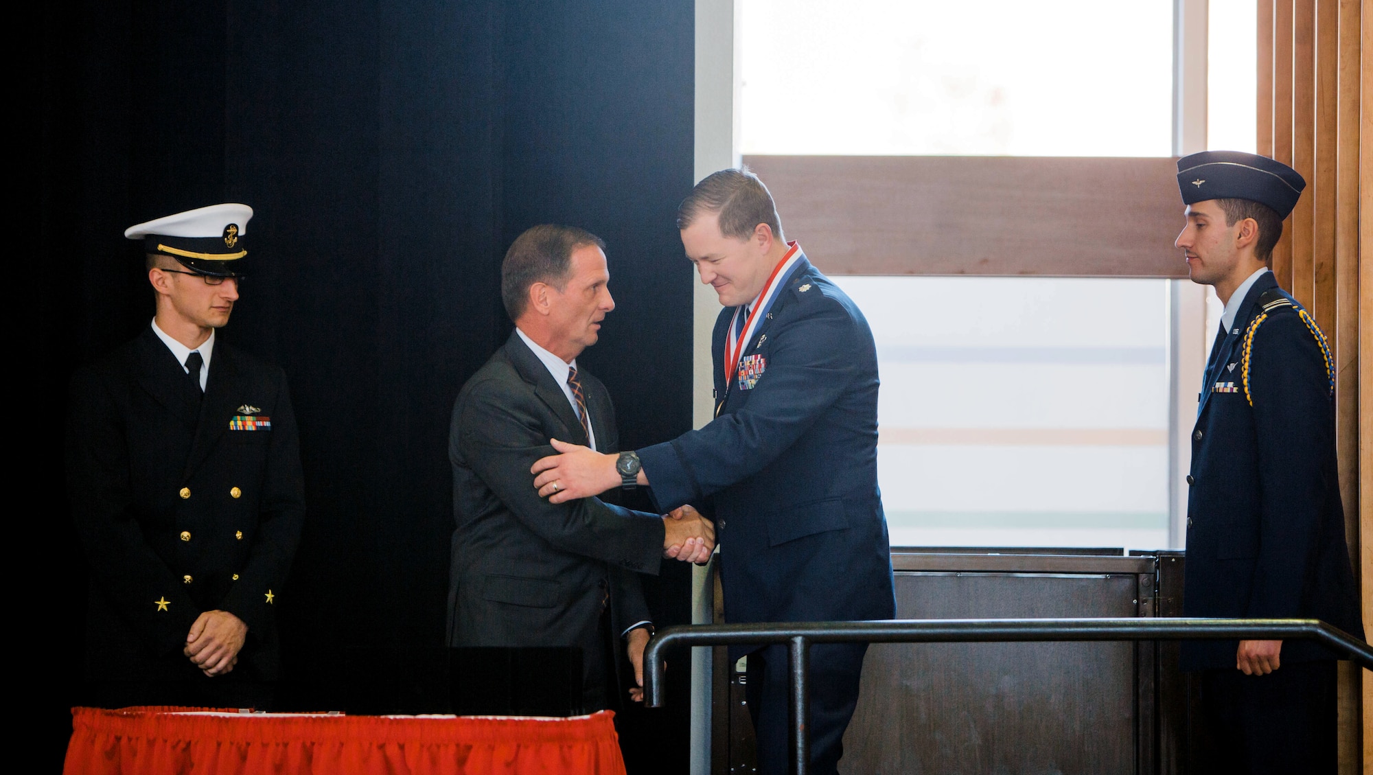 Lt. Col. TJ Eaton, reservist in the 419th Inspector General office, accepts a medal from Rep. Chris Stewart during a Veterans Day program Nov. 9 at the University of Utah.