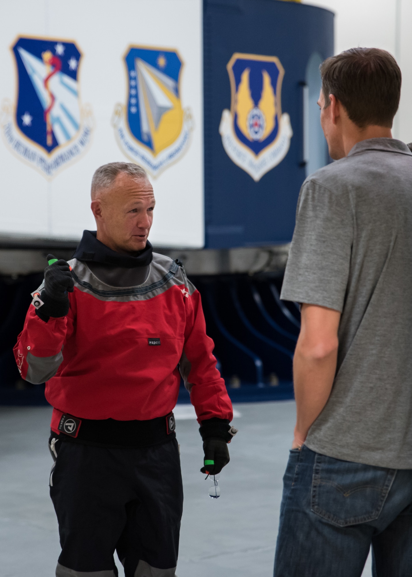 NASA astronaut Douglas Hurley speaks with a NASA engineer just before getting into the Air Force Research Laboratory’s centrifuge. Ten astronauts participated in the testing Nov. 1 and 2 – one with Boeing and nine with NASA.