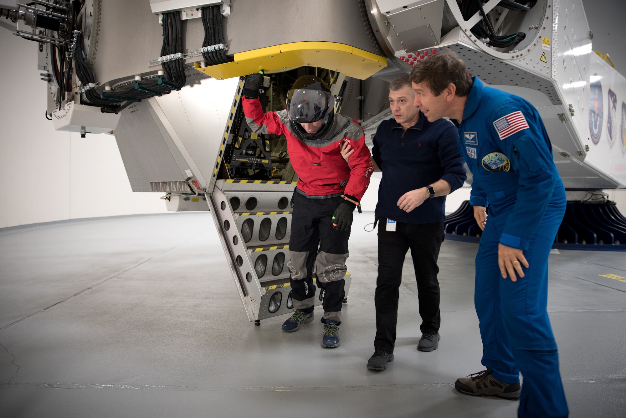 NASA spacesuit engineer Ian Meginnis is helped down from the centrifuge by KBRwyle contractor Brent Ochs with the Air Force Research Laboratory and NASA astronaut and physician Dr. Michael Barratt following his spin during centrifuge testing Nov. 1 and 2.