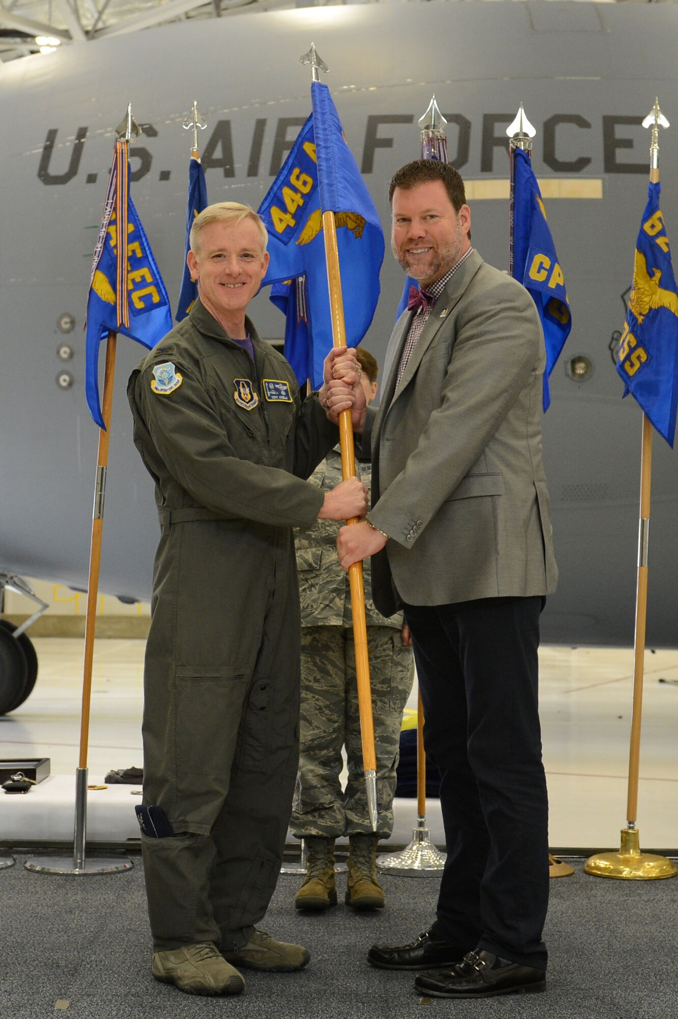 Col. Tony P. Angello, 446th Airlift 'Rainier' Wing interim commander, exchanges the 446th AW guidon flag with City of Lacey Mayor Andy Ryder. Mayor Ryder is the first ever Rainier Wing Honorary Commander. (U.S. Air Force photo by Airman First Class Sara Hoerichs)