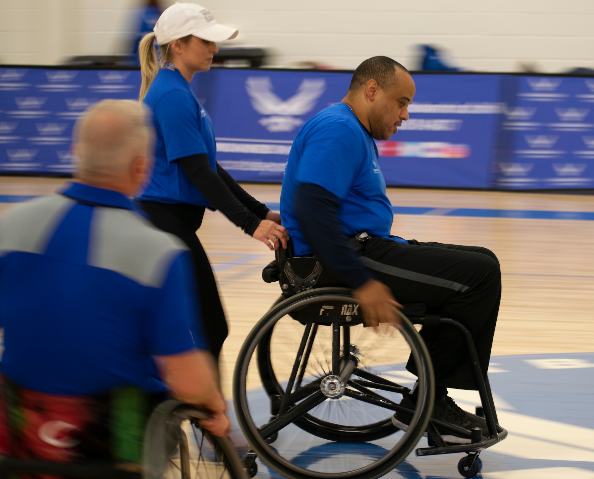 Tech Sgt. Robert Cowherd moves up the court during wheelchair basketball practice at the NE Region Warrior CARE Event at Joint Base Andrews, MD.