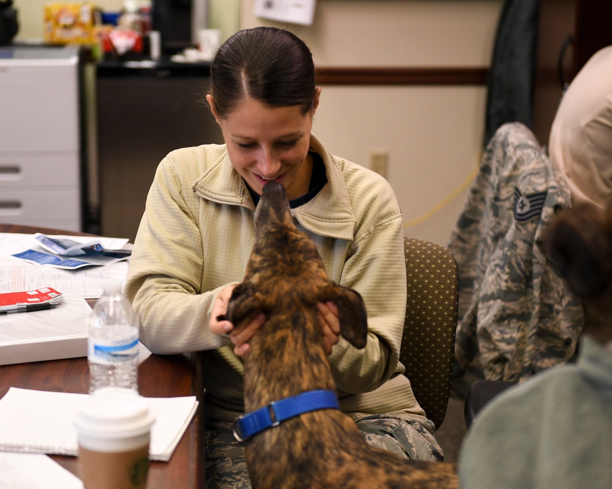 Boris, therapy dog with the 911th Airlft Wing, greets Tech. Sgt. Allissa Landgraff, broadcaster with the 911th AW, at the Pittsburgh International Airport Air Reserve Station, Pennsylvania, October 13, 2018. Boris’ primary role at the 911th AW is to improve morale and lift the spirits of anyone in need, which is accomplished through animal-assisted activities.