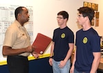 Petty Officer 1st Class Harold Dayse, leading petty officer assigned to Navy Recruiting Station New Braunfels, Navy Recruiting District San Antonio, speaks with future Sailors and twin brothers, Jack and James Lanier of Universal City, Texas, regarding the Navy’s Delayed Entry Program at the NRS during the twin’s 72-hour indoctrination process.  The Lanier brothers are seniors at Marion High School in Marion, Texas, and joined the Navy in the nuclear propulsion program which currently is awarding bonuses of up to $40,000.