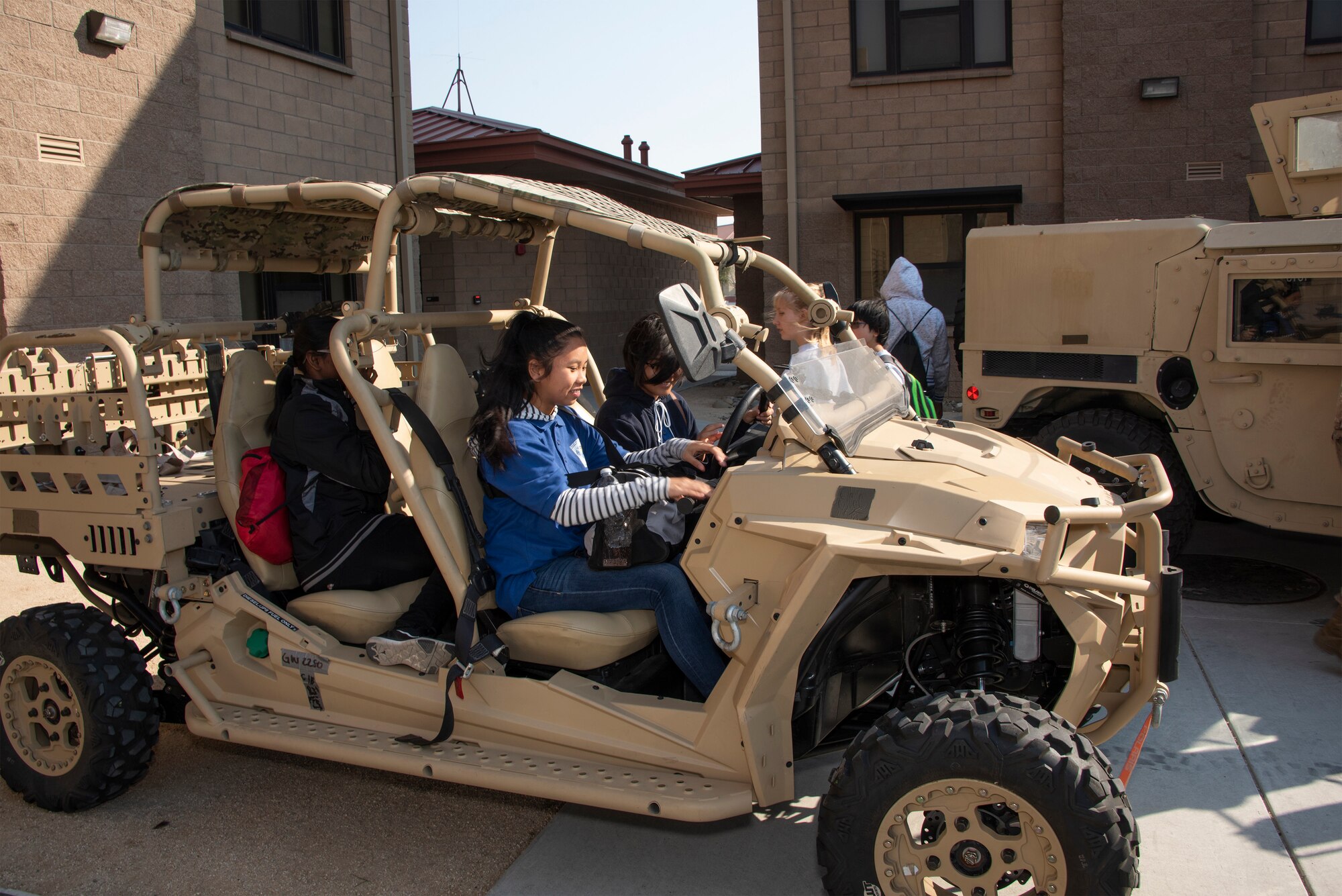 Students check out a security forces all-terrain vehicle during a base tour, Nov. 8, 2018, Travis Air Force Base, California. Travis hosted Junior Reserve Officer Training Corps students from three high schools in Northern Calif. Students learned about various career fields in the U.S. Air Force, toured static aircraft, a dormitory, and had the opportunity to talk with personnel about military life. (U.S. Air Force photo by Heide Couch)