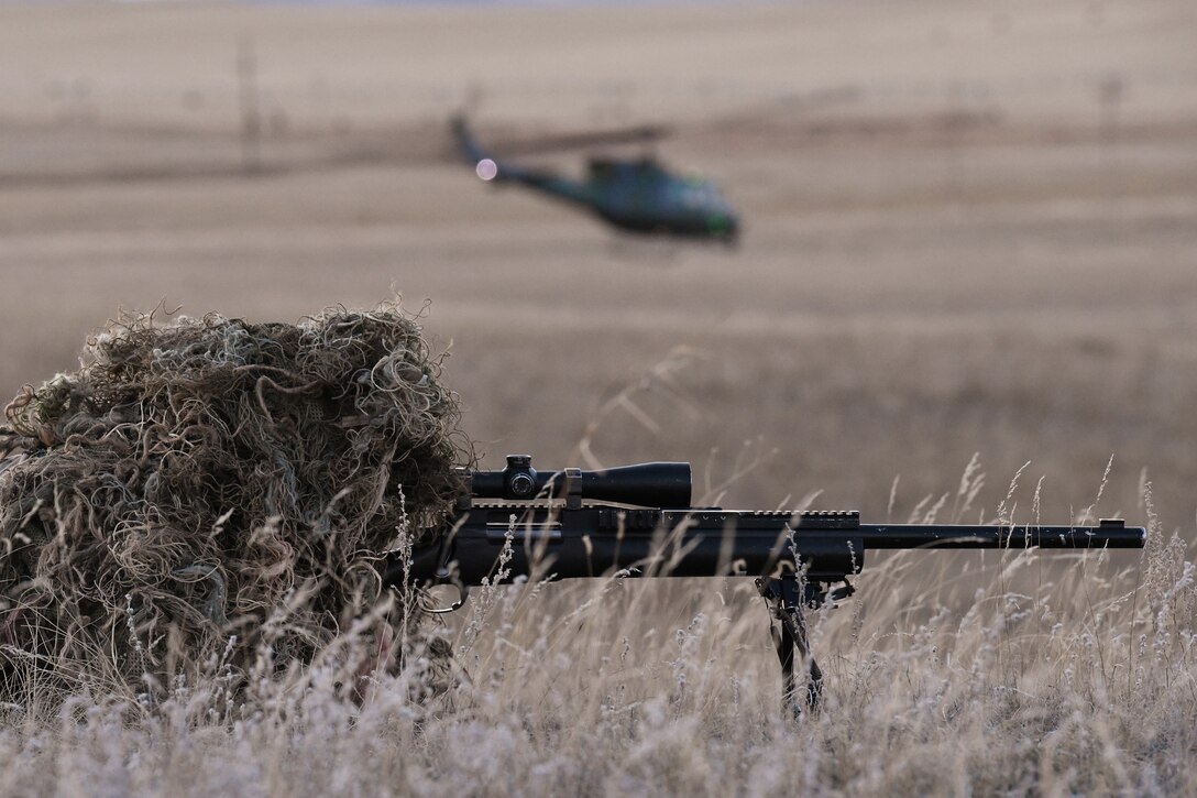A nuclear advanced designated marksman from the 341st Security Support Squadron Tactical Response Force watches as a helicopter offloads other members in support of a launch facility recapture exercise during Global Thunder 19, Oct. 30, 2018, at Malmstrom Air Force Base, Mont.