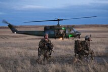 Members of the 341st Security Forces Group prepare to load a helicopter assigned to the 40th Helicopter Squadron during a launch facility recapture exercise during Global Thunder 19, Oct. 30, 2018, at Malmstrom Air Force Base, Mont.