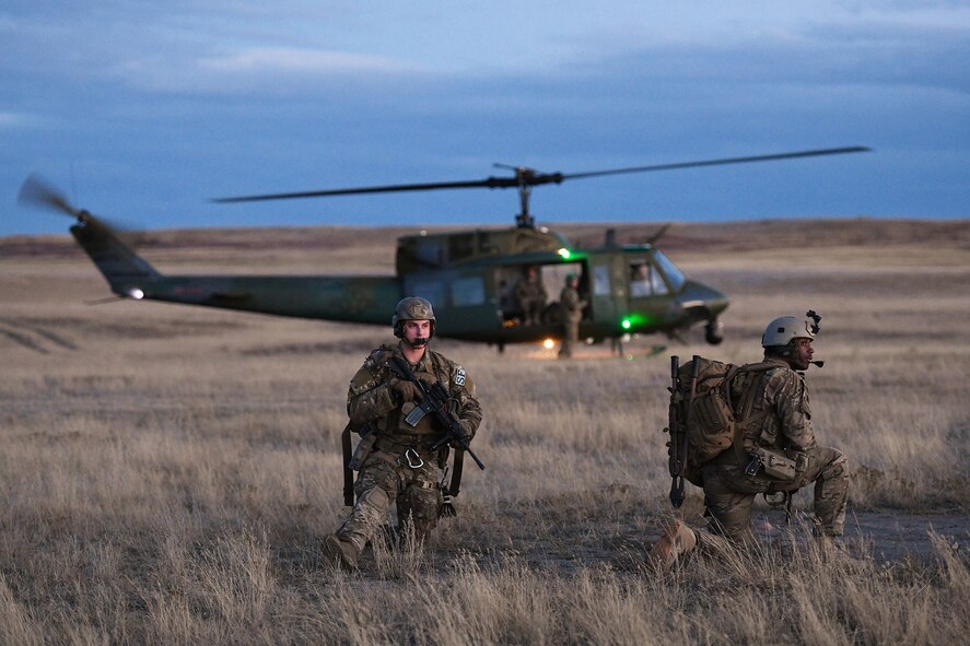 Members of the 341st Security Forces Group prepare to load a helicopter assigned to the 40th Helicopter Squadron during a launch facility recapture exercise during Global Thunder 19, Oct. 30, 2018, at Malmstrom Air Force Base, Mont.