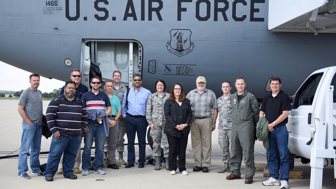 DCMA team stands in front of a KC-135 on the flight line.