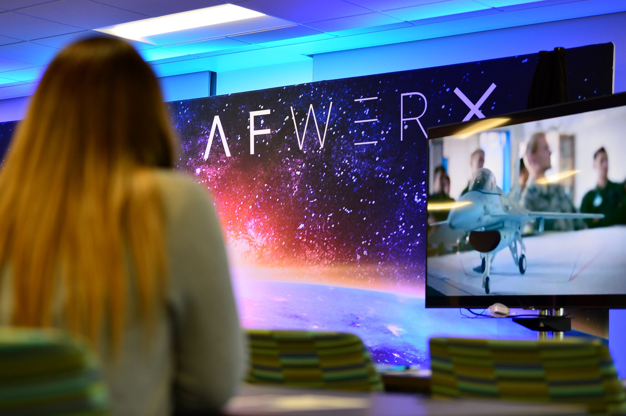 Airman 1st Class Danielle, 799th Security Forces Squadron security forces member, watches a video explaining the AFWERX mission Nov. 5, 2018, in Las Vegas. The off-site program served as an opportunity to get ideas flowing, accelerate results and learn more about the resources available to problem solvers. (U.S. Air Force Photo by Airman 1st Class Haley Stevens)