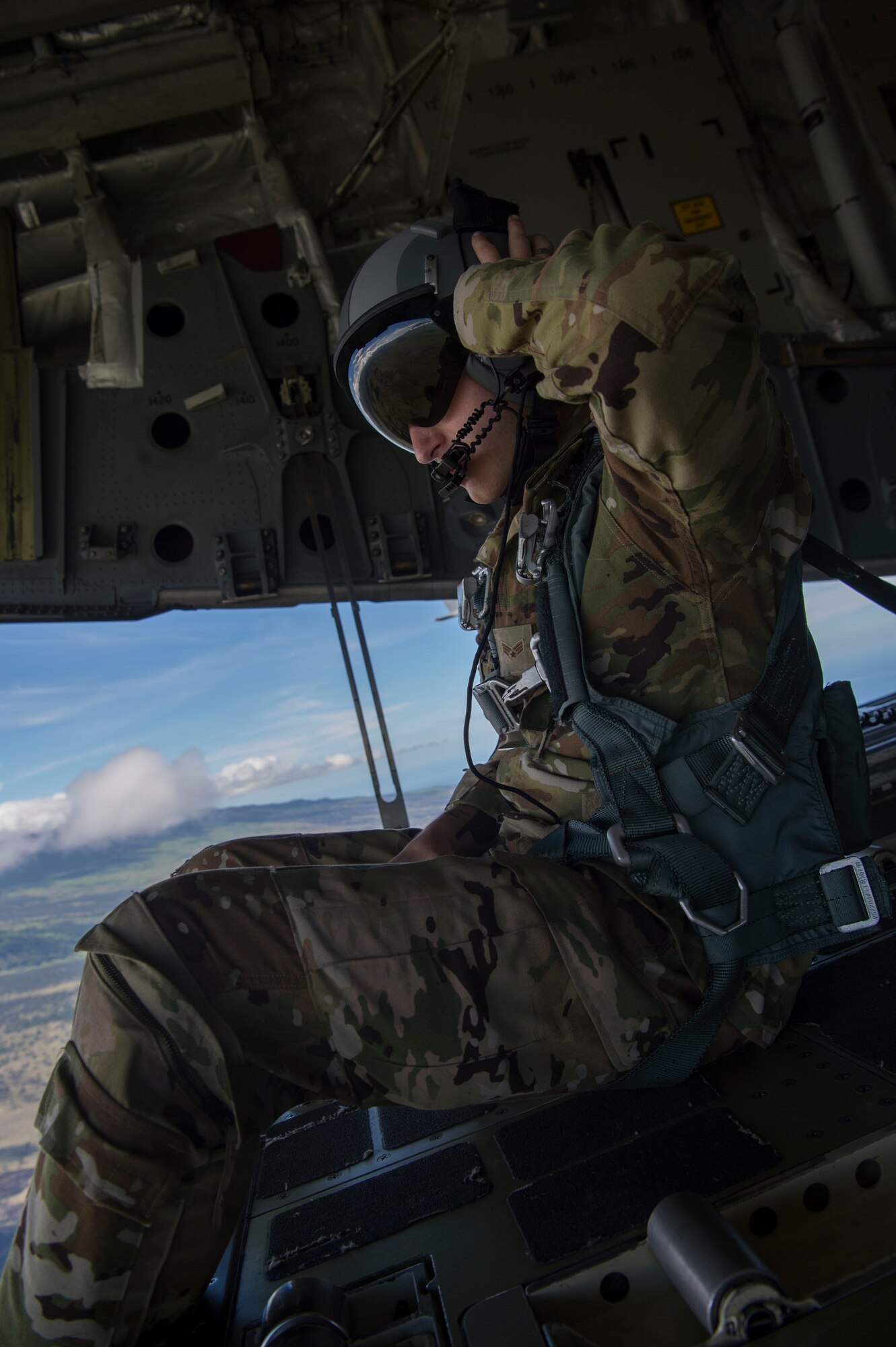 Senior Airman Trenton Turner, 535th Airlift Squadron loadmaster, sits on the ramp of a C-17 Globemaster III, during Big Island Drop Week, on Hilo, Hawaii Nov. 7, 2018. Big Island Drop Week enabled aircrews to conduct airdrops in an austere terrain that is not found on Oahu, Hawaii. (U.S. Air Force photo by Tech. Sgt. Heather Redman)