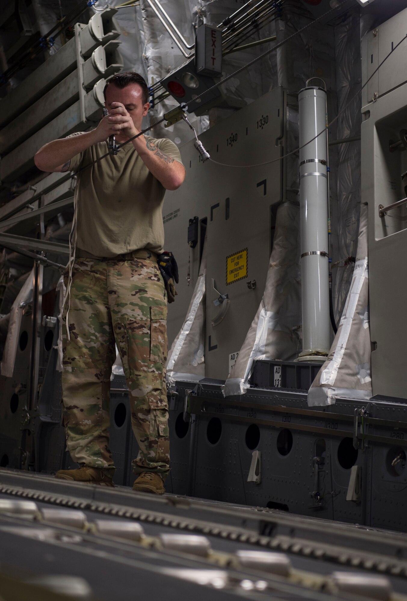 Senior Airman Ryan Stefanowicz, 535th Airlift Squadron loadmaster, secures a line for a container delivery system on board a C-17 Globemaster III during Big Island Drop Week, Joint Base Pearl Harbor-Hickam, Hawaii Nov. 8, 2018. Big Island Drop Week helps prepare the 15th Wing to meet future operational needs and accomplish the mission of employing combat power across the Indo-Pacific. (U.S. Air Force photo by Tech. Sgt. Heather Redman)