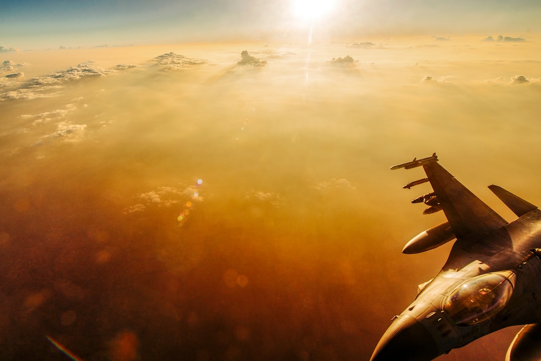 An Air Force F-16 Fighting Falcon receives fuel mid-flight from a KC-135 Stratotanker