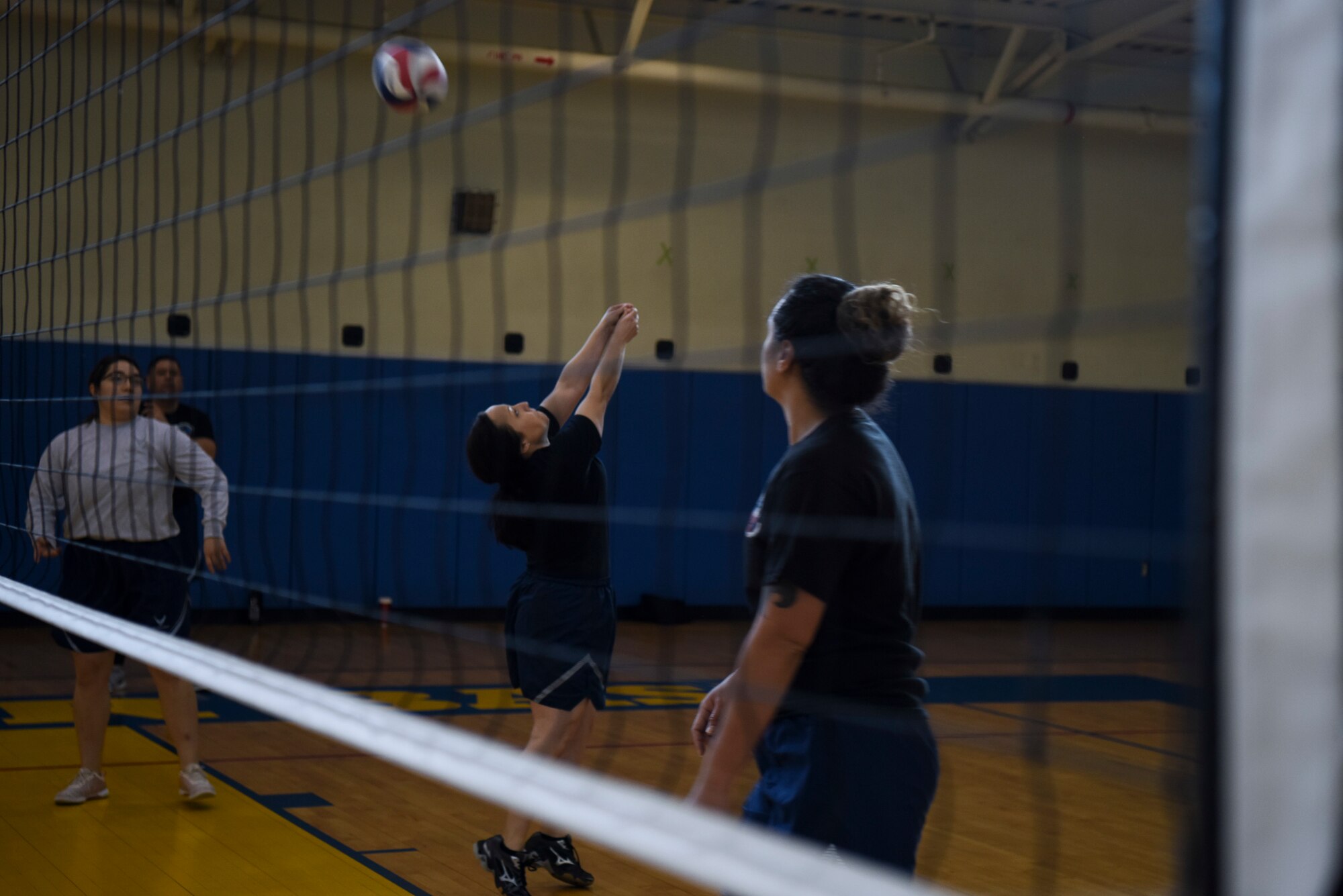 U.S. Air Force Tech. Sgt. Avery Hooper, 8th Operations Support Squadron intelligence analysis section chief, passes a volleyball over the net during the 2018 US-ROKAF Friendship Day at Kunsan Air Base, Republic of Korea, Nov. 9, 2018. Participants competed in a variety of sports and interactive events, such as basketball, volleyball, League of Legends, golf, bowling, and soccer. (U.S. Air Force photo by Senior Airman Savannah L. Waters)