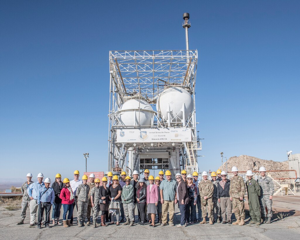 Honorary Commanders pose for a photo in front of rocket engine test stand during a tour of the Air Force Research Laboratory "Rocket Lab" at Edwards Air Force Base, California, Nov. 9 (U.S. Air Force photo by Edward Cannon)
