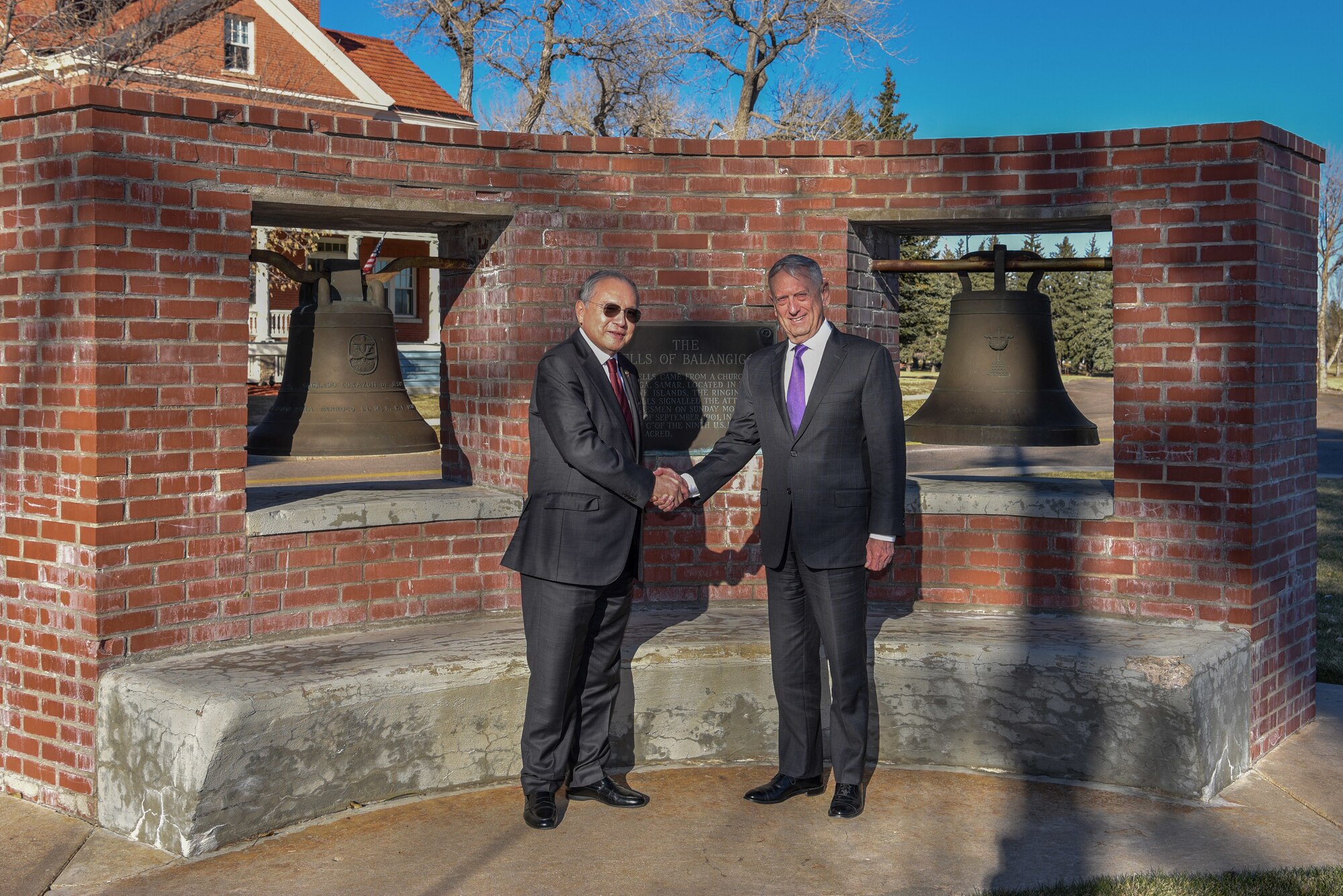 Jose Romualdez, Philippine Ambassador to the United States, and Defense Secretary James N. Mattis, stand for a photo, Nov. 14, 2018, in front of the bells of Balangiga on F.E. Warren Air Force Base, Wyo. During the visit, the Bells of Balangiga were officially presented to the Philippine government. (U.S. Air Force photo by Airman 1st Class Braydon Williams)