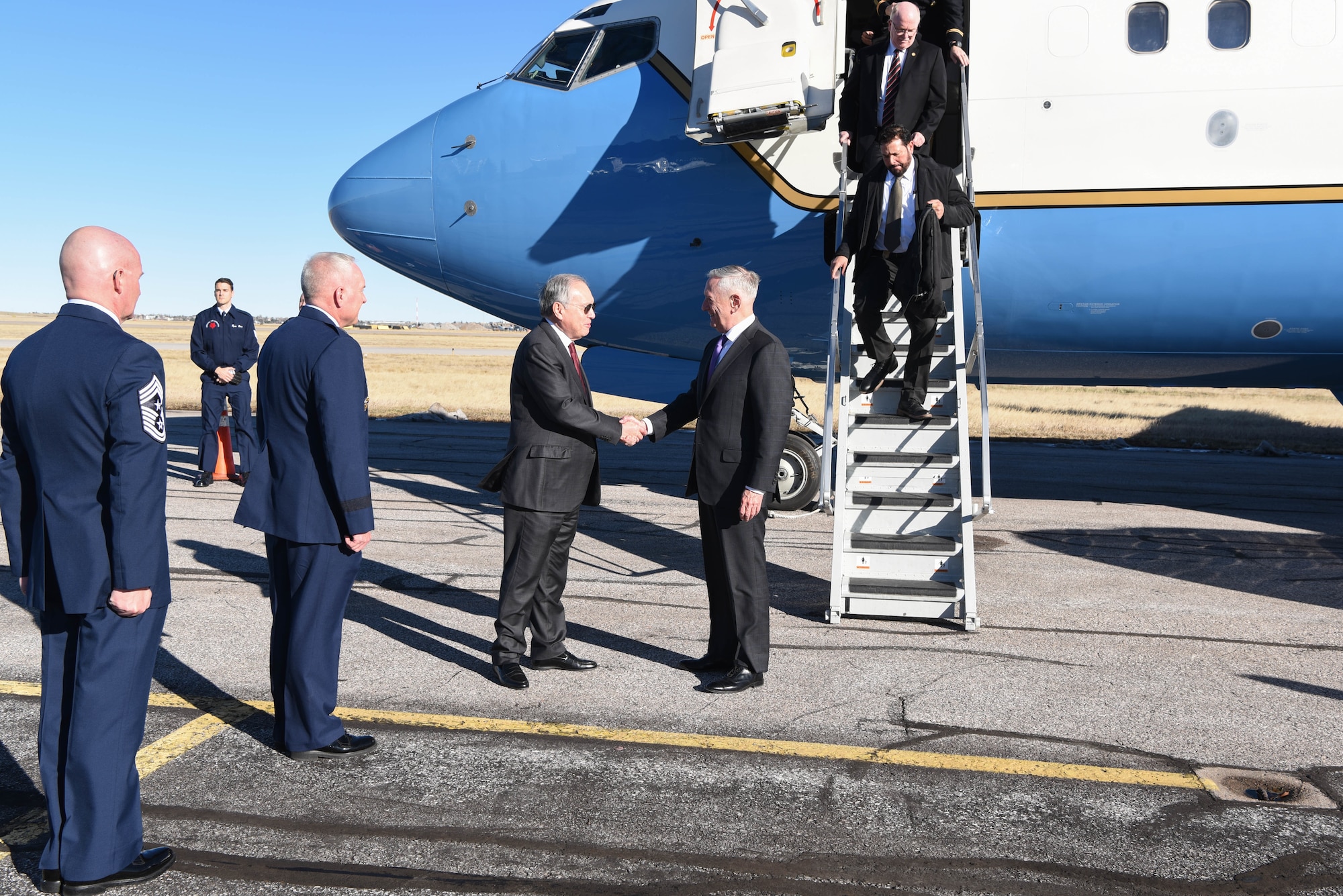 Jose Romualdez, Philippine Ambassador to the United States, Maj. Gen. Fred Stoss, 20th Air Force commander, and Chief Master Sgt. Thomas Good, 20th Air Force command chief, greets Defense Secetary James N. Mattis plade side Nov. 14, 2018, at Cheyenne Regional Airport, Wyo. Suring the Defense Secretary's visit to F.E. Warren Air Force Base, Wyo., the Bells of Balangiga were officially presented to the Philippine government. (U.S. Air Force photo by Airman 1st Class Abbigayle Wagner)