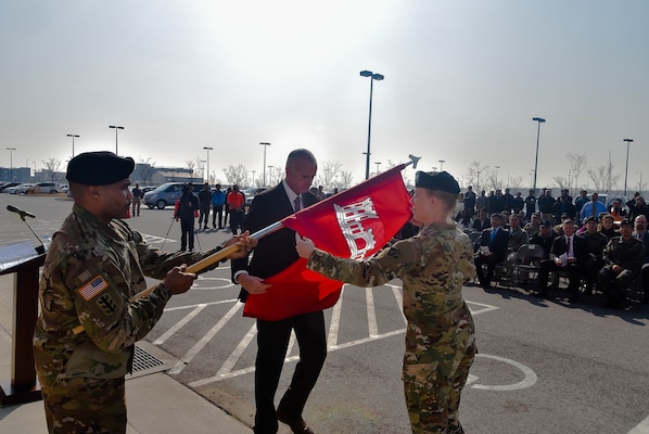 Col. Teresa Schlosser (right), U.S. Army Corps of Engineers (USACE), Far East District (FED) commander, and Richard Byrd (left), USACE FED Deputy District Engineer, prepare to unfurl the unit's colors during an uncasing ceremony held at the district's headquarters, Camp Humphreys, South Korea, Nov. 14.