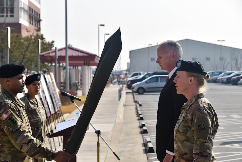 Col. Teresa Schlosser (right), U.S. Army Corps of Engineers (USACE), Far East District (FED) commander, and Richard Byrd (left), USACE FED Deputy District Engineer, prepare to unfurl the unit's colors during an uncasing ceremony held at the district's headquarters, Camp Humphreys, South Korea, Nov. 14.