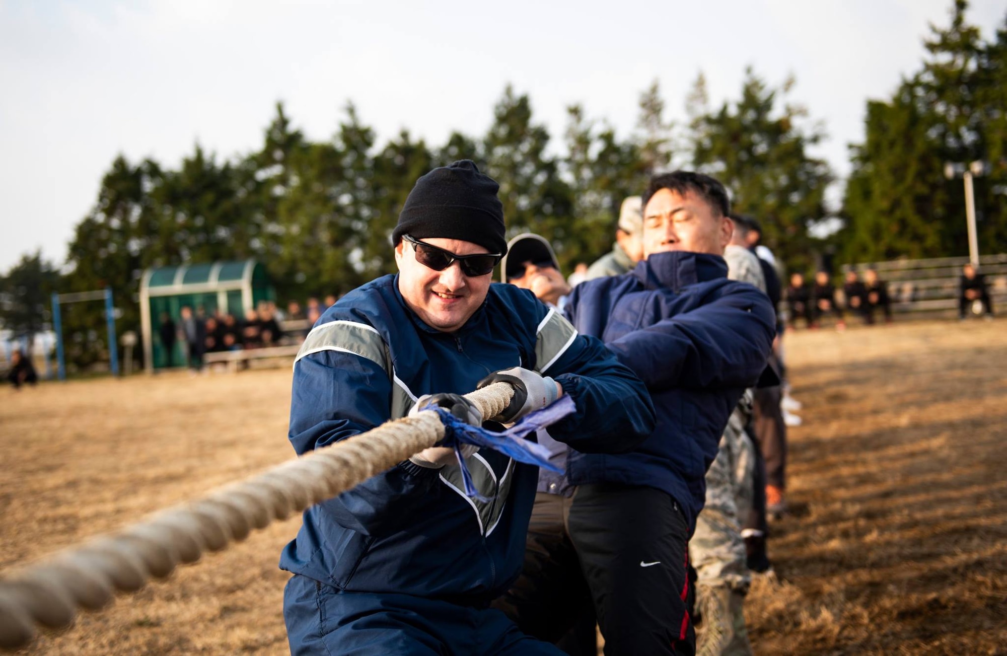 Col. John Bosone, 8th Fighter Wing commander (left), and Col. Jae-Gyun Jeon, 38th Fighter Group commander (right), pull a rope in a game of tug-of-war at Kunsan Air Base, Republic of Korea, Nov. 9, 2018. Participants in the 2018 US-ROKAF Friendship Day competed in a variety of sports and interactive events, such as basketball, volleyball, the video game “League of Legends”, golf, bowling, and soccer. (U.S. Air Force photo by Senior Airman Stefan Alvarez