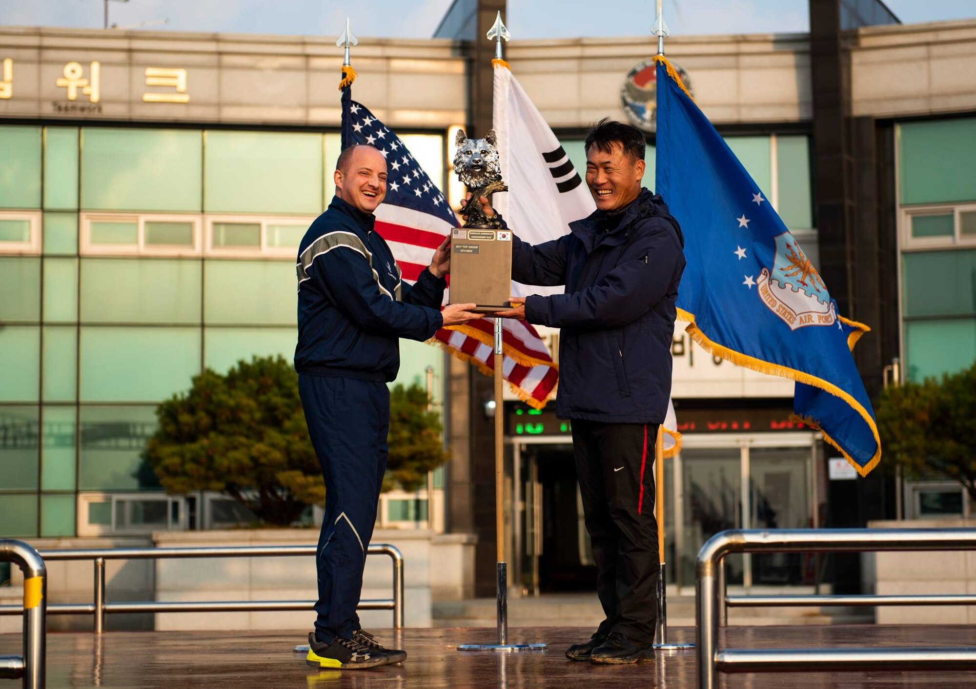 Col. John Bosone, 8th Fighter Wing commander (left), presents Col. Jae-Gyun Jeon, 38th Fighter Group commander (right), with the 2018 US-ROKAF Friendship Day trophy at Kunsan Air Base, Republic of Korea, Nov. 9, 2018. The US-ROKAF Friendship Day focused on celebrating the partnership and alliance between the 8th FW and 38th FG, who participated in several sporting events and competitions throughout the day. (U.S. Air Force photo by Senior Airman Stefan Alvarez)