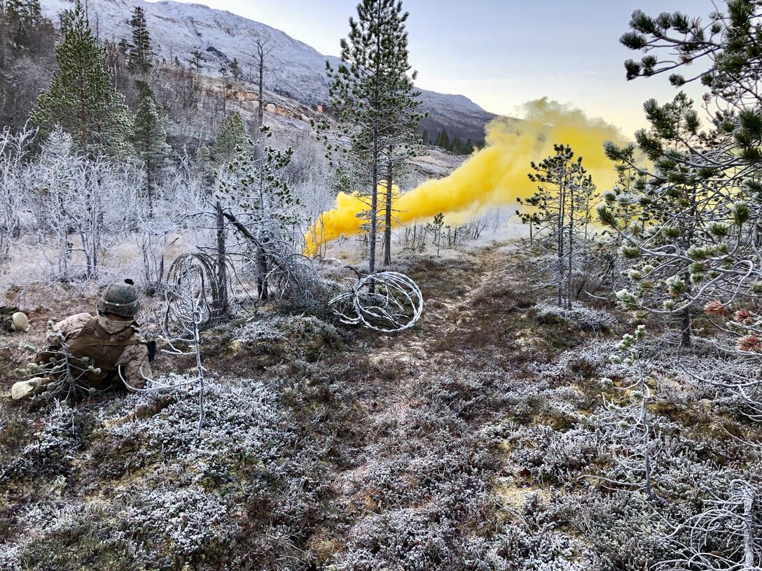 A U.S. Marine with Marine Rotational Force-Europe 19.1 (MRF-E), sets a marker during a squad attack as a part of Exercise Northern Screen in Setermoen, Norway, Nov. 28, 2018. The exercise increases the Marines’ proficiency in cold-weather, arctic, and mountainous environments. (Courtesy Asset)