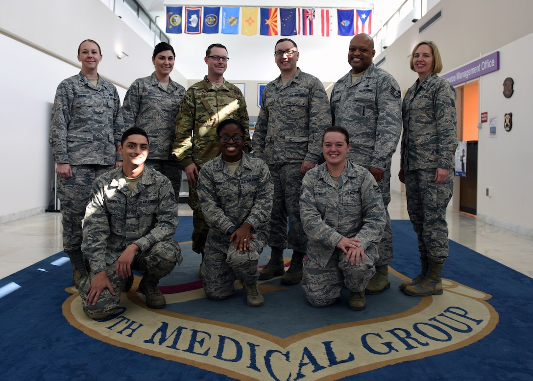 The Mental Health flight poses for a group photo in front of the 39th Medical Group shield at Incirlik Air Base, Turkey, Nov. 7, 2018.