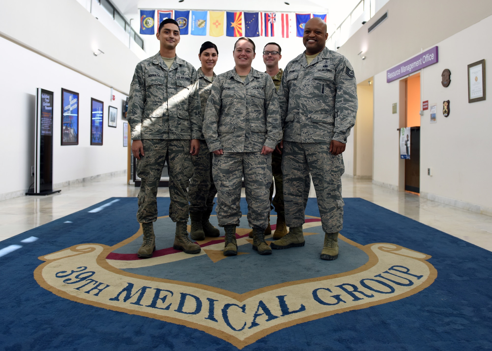 Five mental health Airmen in a group photo.