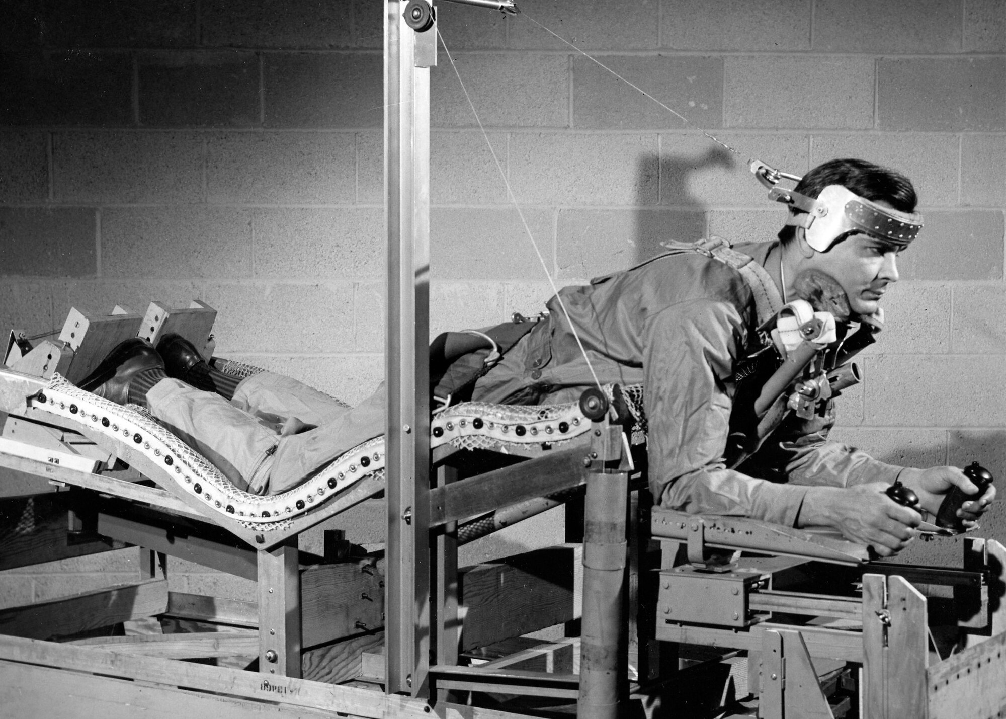 U.S. Air Force Aeromedical Laboratory scientists test a prone-position “pilot bed,” on February 3, 1949. AFRL designed the bed to relieve the gravitational stress on pilots, as part of research to solve medical challenges presented by space flight. (U.S Air Force photo)