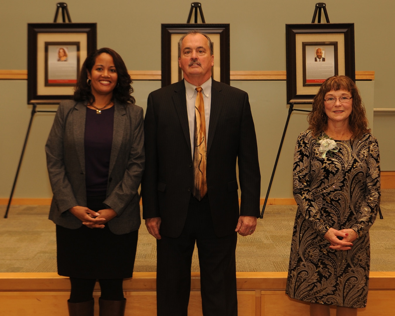 Carolyn Williford-Jackson (left), Keith Ford (center) and Jacqueline Basquill pose in front of framed plaques during the Defense Logistics Agency Troop Support Hall of Fame induction ceremony Nov. 13, 2018 in Philadelphia.