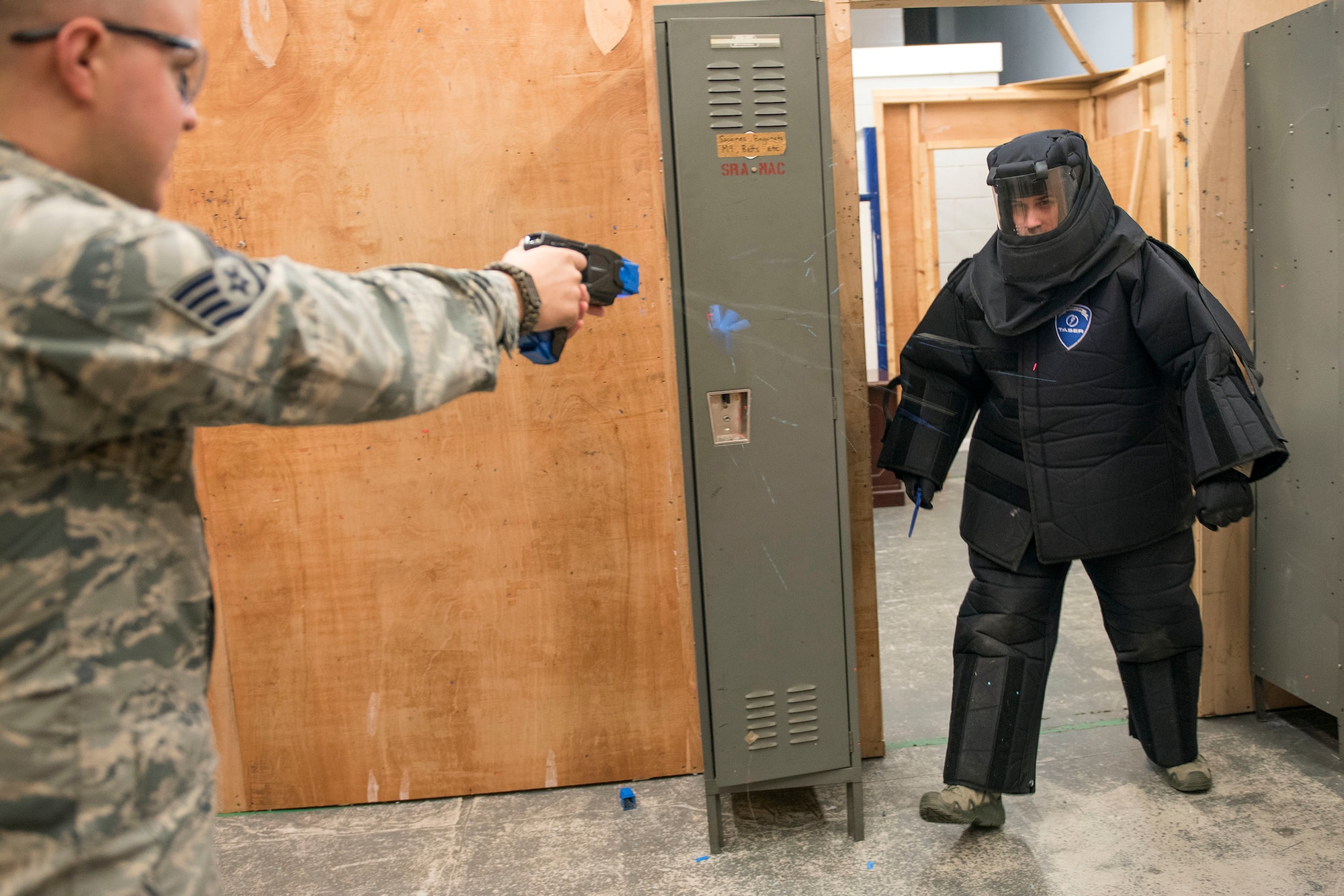 U.S. Air Force Staff Sgt. Thomas Hartline, 100th Security Force Squadron base defense operations controller, tases U.S. Air Force Senior Airman Kory Bruner, during training at RAF Mildenhall, England, Nov. 8, 2018. At the minimum, Airmen on duty are required to don a baton, and have the option to carry a Taser. (U.S. Air Force photo by Staff Sgt. Christine Groening)