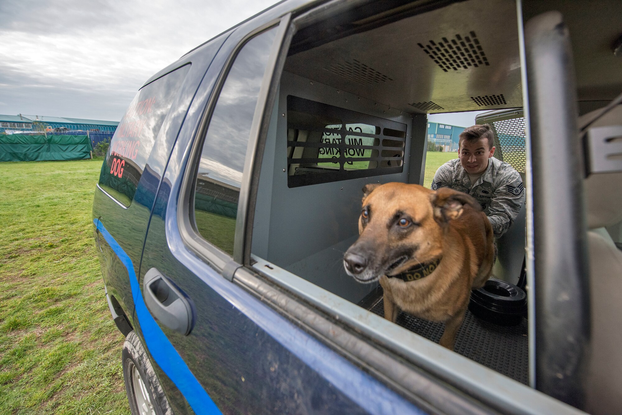 U.S. Air Force Staff Sgt. Camron Quaranto, 100th Security Force Squadron Military Working Dog Handler and MWD Tomi practice jumping out of a vehicle as part of their daily training at RAF Mildenhall, England, Nov. 6, 2018. The MWD teams implement use of force training on a daily basis, also known as “six-phases of aggression.” (U.S. Air Force photo by Staff Sgt. Christine Groening)