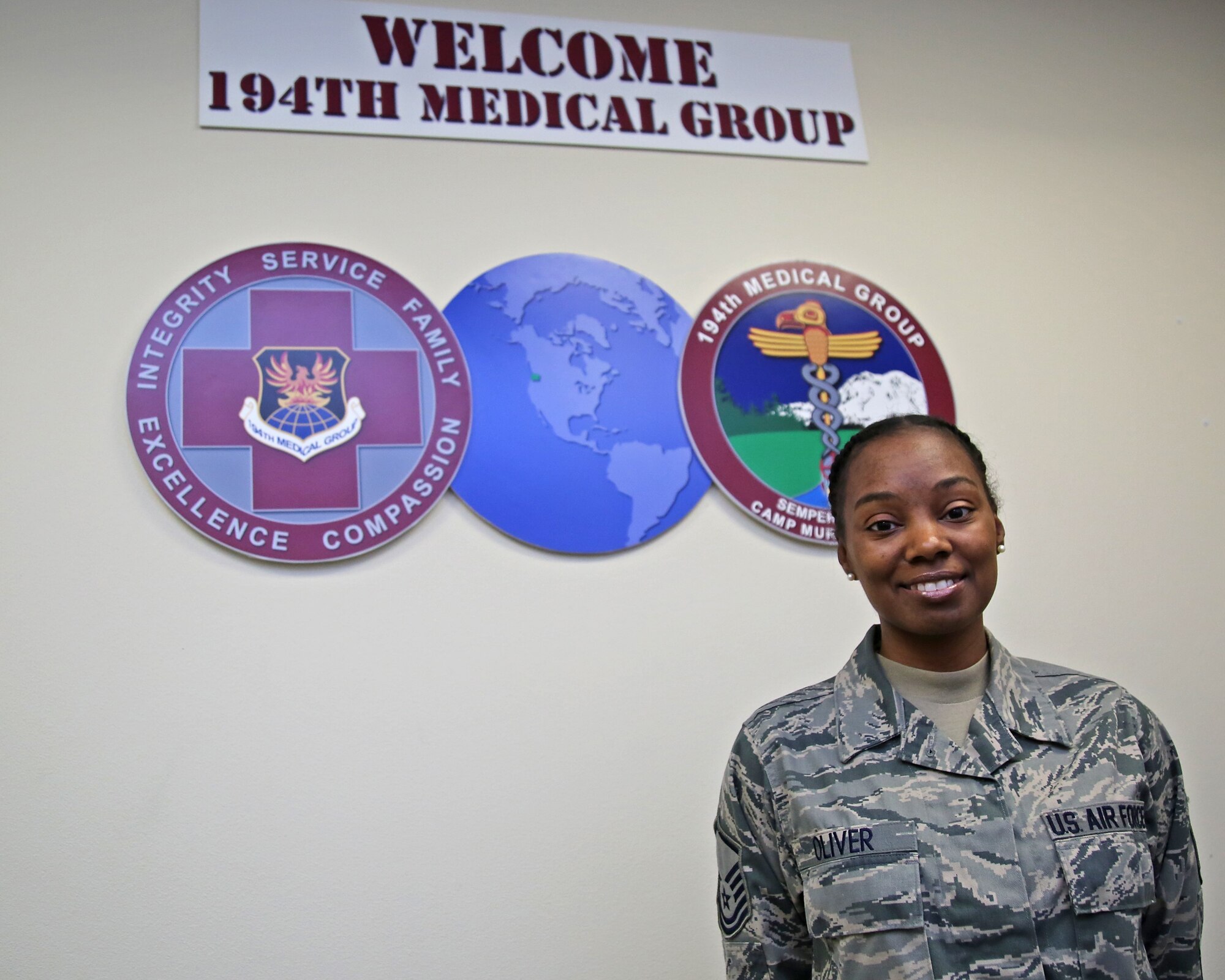 Master Sgt. Khalilah Oliver, a medical administrator assigned to the Washington Air National Guard's 194th Medical Group, stands in a reception area, Nov. 4, 2018. (U.S. Air Force photo by Airman 1st Class Mckenzie Airhar)