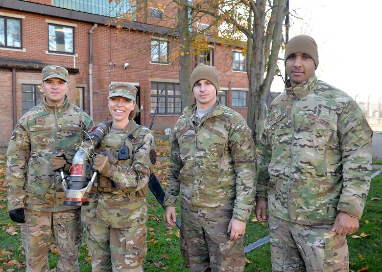 U.S. Air Force Chief Master Sgt. Juliet Gudgel, Air Education and Training Command command chief, poses for a photo with Tech. Sgt. Joshua Lopez, Senior Airman Cory Irvine, and Senior Airman Michael Ricci, 100th Logistics Readiness Squadron forward area refueling point operators, during a FARP demonstration at RAF Mildenhall Nov. 14, 2018.  As a wrap up to visiting U.S. Air Forces in Europe and Air Force-Africa. Gudgel was accompanied by Chief Master Sgt. Charles Frizzell, 59th Medical Wing command chief, have been on the road to talk to Airmen, supervisors, commanders, first sergeants and unit training managers on how AETC can better train Airmen across the Air Force. (U.S. Air Force photo by Karen Abeyasekere)
