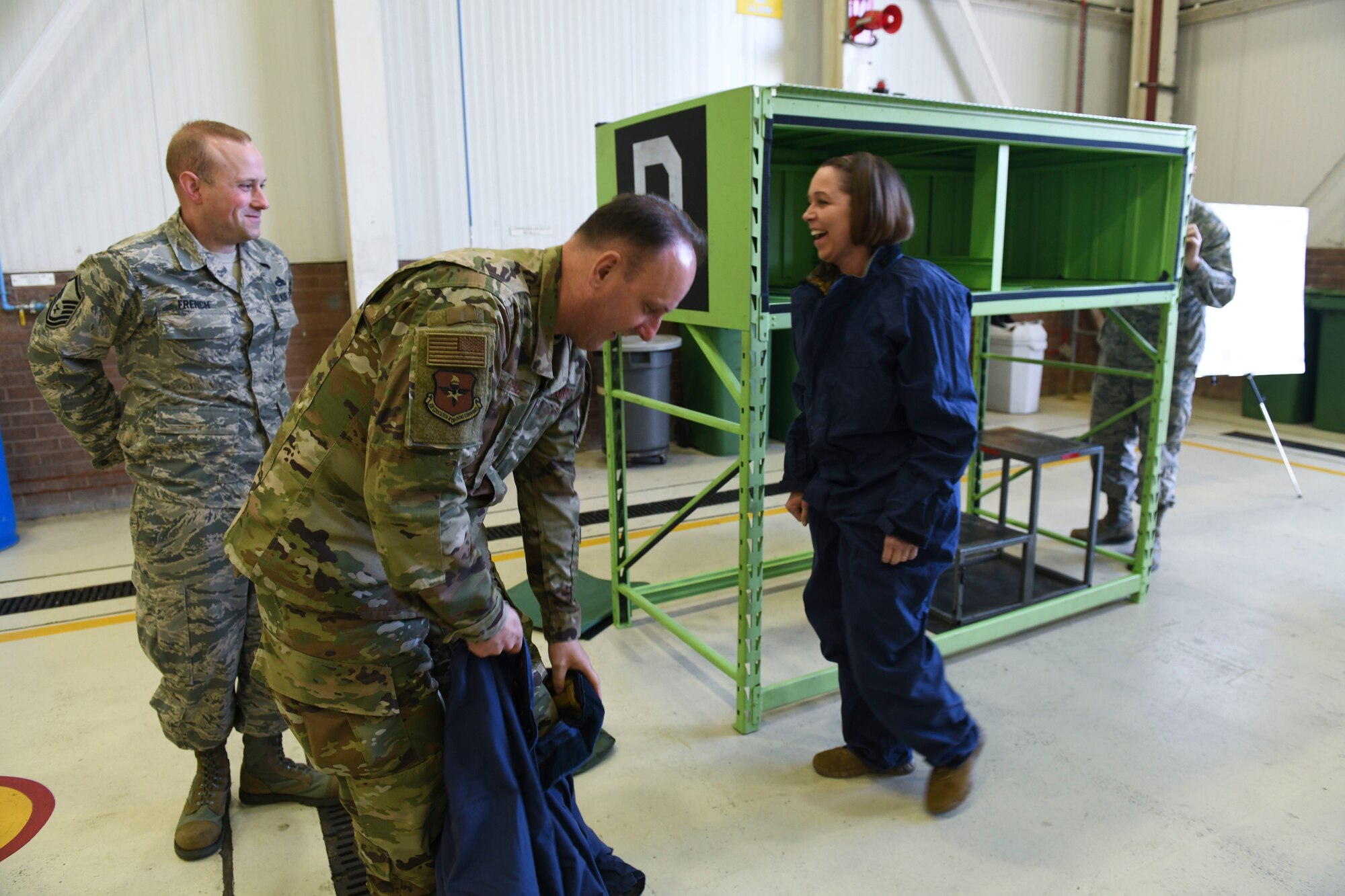 U.S. Air Force Master Sgt. Troy French, 100th Maintenance Squadron aircraft fuels system section chief, Chief Master Sgt. Charles Frizzell, 59th Medical Wing command chief, and Chief Master Sgt. Juliet Gudgel, Air Education and Training Command command chief, prepare to test out the maintenance squadron’s confined space trainer at RAF Mildenhall, England, Nov. 14, 2018.  The chiefs were presented with the 100th MXS innovation to show how those innovations sustain mission effectiveness. (U.S. Air Force photo by Airman 1st Class Alexandria Lee)