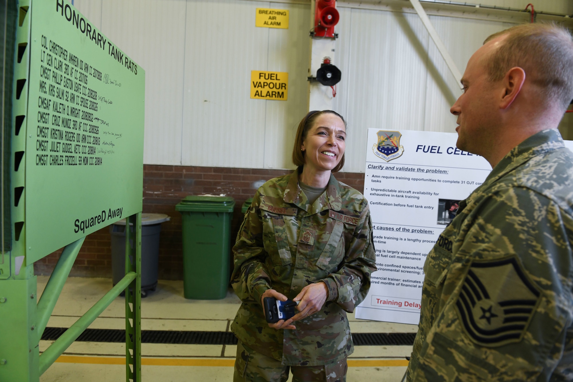 U.S. Air Force Chief Master Sgt. Juliet Gudgel, Air Education and Training Command command chief, and Master Sgt. Troy French, 100th Maintenance Squadron aircraft fuels system section chief, discuss the maintenance squadron’s confined space trainer at RAF Mildenhall, England, Nov. 14, 2018.  The 100th MXS presented the chief with the newest innovation to show how those innovations sustain mission effectiveness. (U.S. Air Force photo by Airman 1st Class Alexandria Lee)