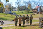 World War II reenactors stand at attention during the playing of Taps in Harrodsburg, Ky., Nov. 10, 2018. Soldiers with the Kentucky National Guard helped host a community-wide event honoring the Harrodsburg Tankers who endured the Bataan Death march in 1942.
