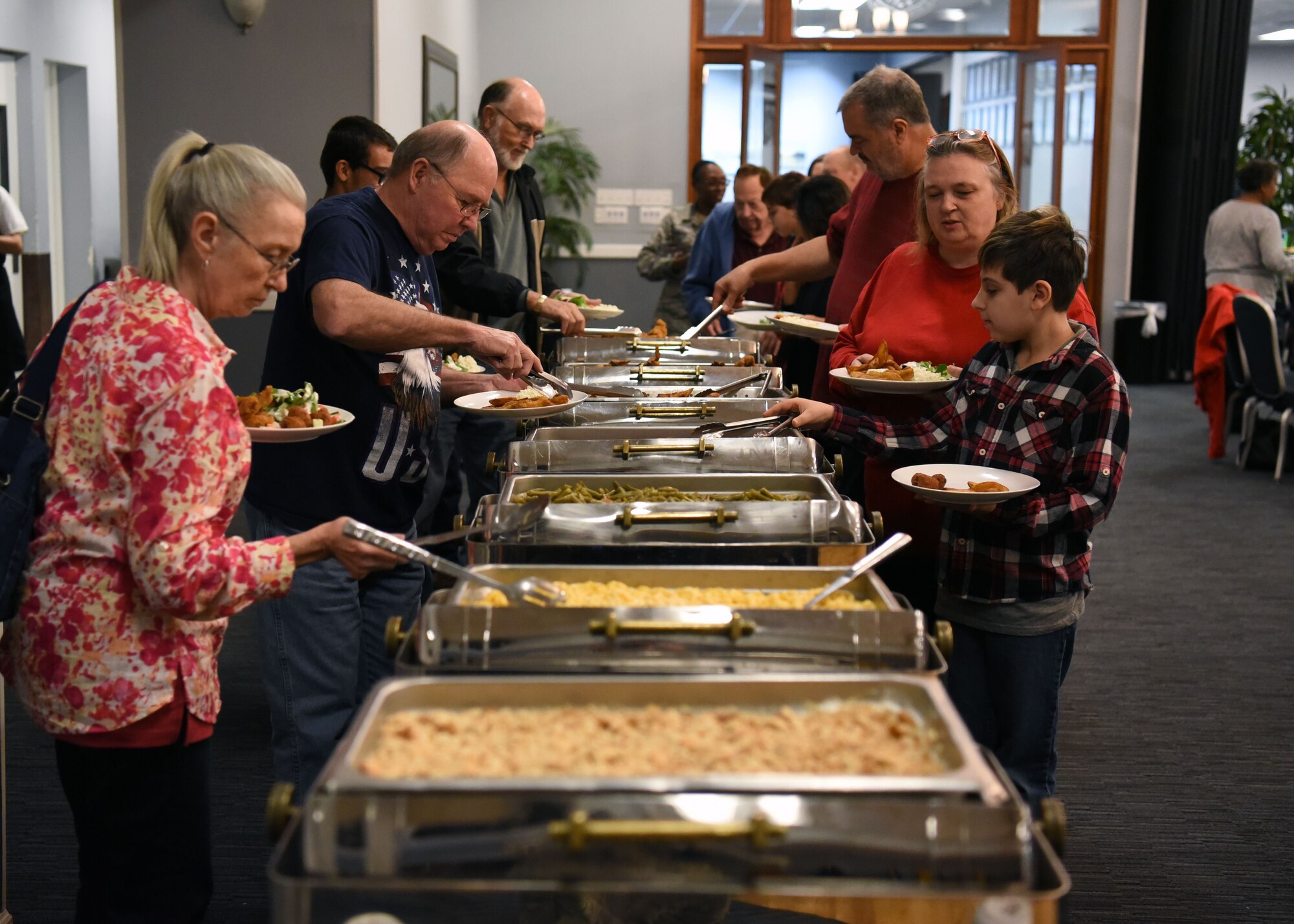 Retirees fill their plates Nov. 9, 2018, during the Retiree Appreciation Day on Columbus Air Force Base, Mississippi. During the event, retirees were treated with a free lunch buffet, raffle prizes, a medical expo and free flu shots. (U.S. Air Force photo by Staff Sgt. Joshua Smoot)