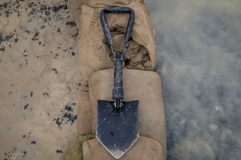 An entrenching tool rests on a sandbag barrier built to divert flood waters after a heavy rainstorm at Camp Arifjan, Kuwait, November 15, 2018. The flooding came after an unusually heavy rainstorm hit the area, which has already experienced significant rain this month.
