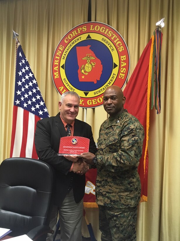 The Safety Award of the Quarter was presented to Phillip Millerd, Comptroller, Marine Corps Logistics Base Albany, during Col. Alphonso Trimble's Safety Council, November 7. The award is earned by a division or department for the combined actions to report near misses, abating any findings during inspection and attending all Voluntary Protection Program committee meetings. (U.S. Marine Corps photo by Re-Essa Buckels)