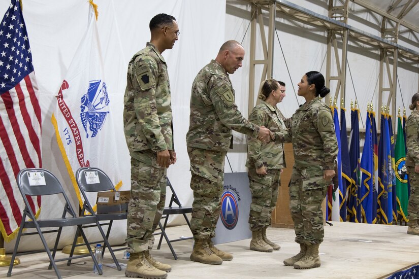 U.S. Army Command Sgt. Maj. Joseph Cornelison, command sergeant major of U.S. Army Central, congratulates a Soldier graduating the latest Basic Leader Course at Camp Buehring, Kuwait, Oct. 17, 2018. The graduates will return to their deployed units as more capable Soldiers, prepared for leadership positions.